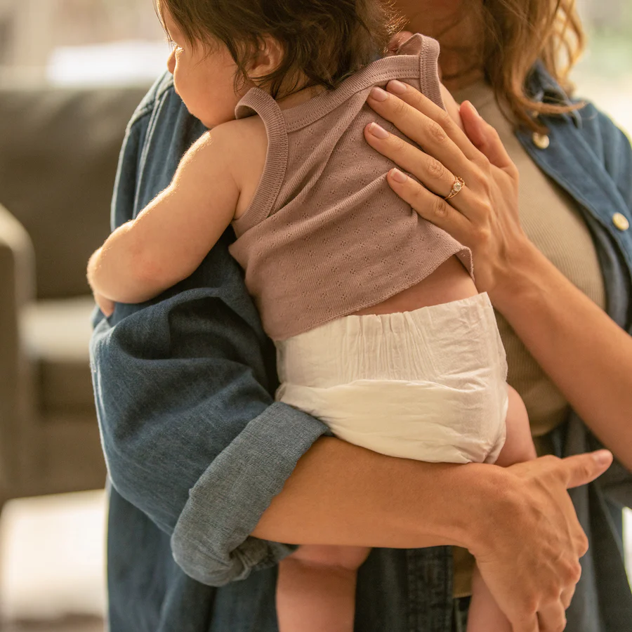 Eight shirts arranged on table in black, olive, grey, blue, white, red, mustard, and green.